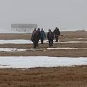 Researchers walk towards site.